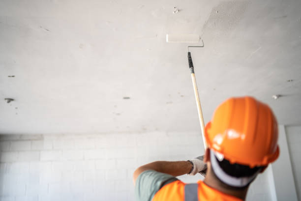 istock Young painter - construction worker painting the ceiling indoors 1436257967