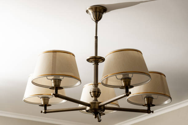 istock A round chandelier of several lamps against a light ceiling, full frame, side view. horizontal frame 1436258073