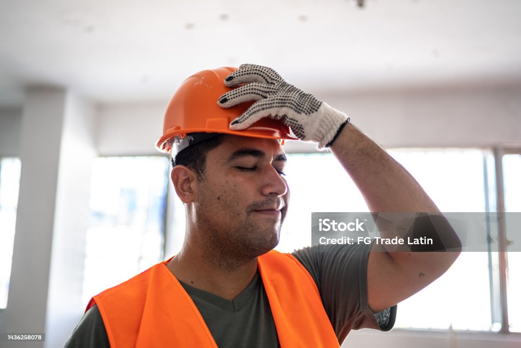 Worried engineer/construction worker working in a construction site Mistake Stock Photo