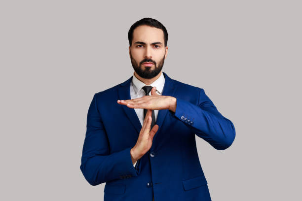 istock Bearded man showing time out gesture, looking with imploring eyes, hurry to meet deadline. 1436258587