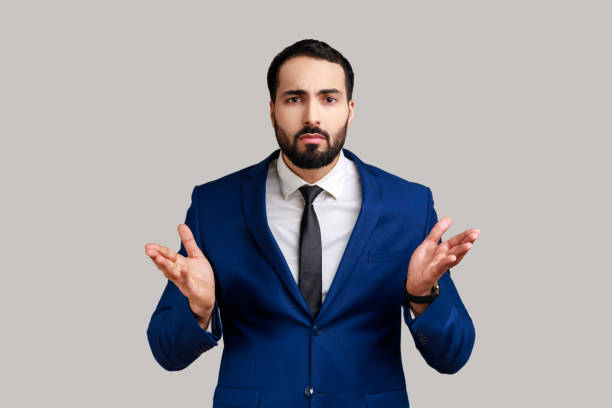istock Bearded man standing with raised hands and confused indignant expression, asking why how what reason 1436258591