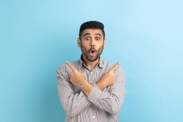 istock Businessman pointing both sides, showing blank copy space for idea presentation, commercial text. 1436259485