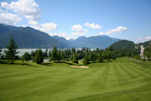 A view of a golf fairway along the Howe Sound with mountains in the background. Located near Squamish, British Columbia, Canada.