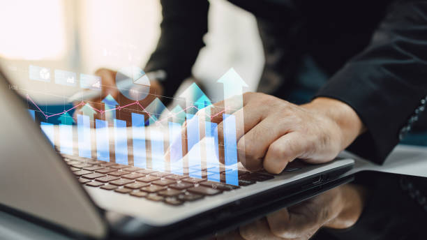 istock Hand of businessman with hologram virtual arrow graph chart on computer notebook representing growth and success of financial economy. Business development to success and growing concept. 1436264398