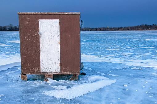 Ice fish house on frozen Minnesota lake.  Fish shack