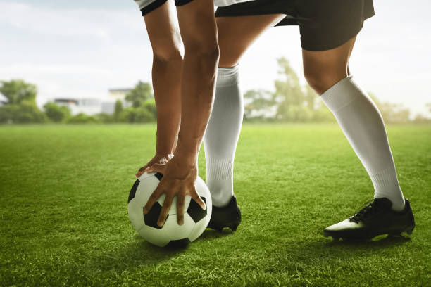 istock Soccer player holding ball on the field 1436274830