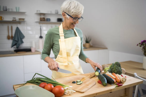istock Woman cutting vegetables 1436277306