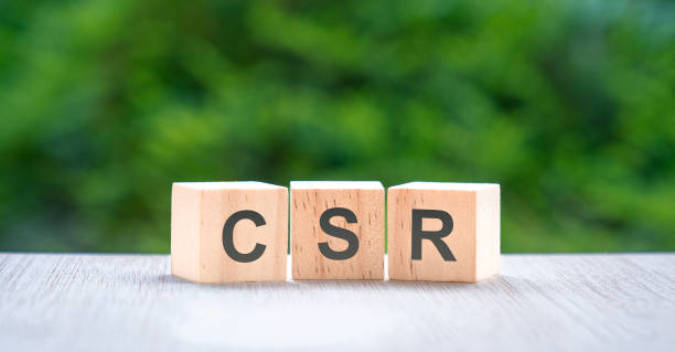 istock CSR, letters on wood block cube with green nature background. 1436277488