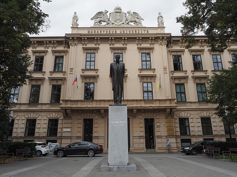 Brno, Czech Republic - Circa September 2022: Masarykova univerzita translation Masaryk university and statue of Tomas Garrigue Masaryk