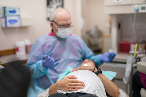 istock Dentist Working On Pregnant Patient 1436278601
