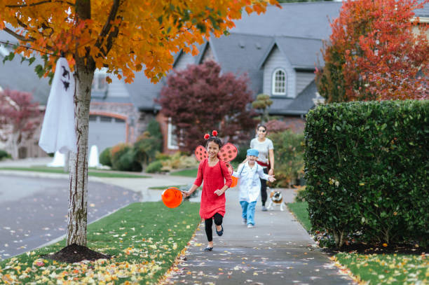 istock Young Family Trick Or Treating Together 1436280150