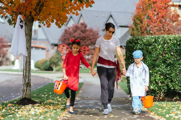 istock Young Family Trick Or Treating Together 1436280159