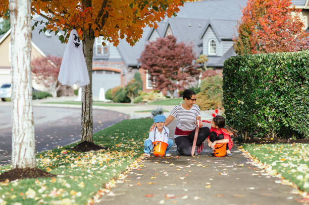istock Young Family Trick Or Treating Together And Posing For Camera 1436280177