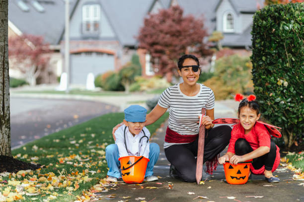 istock Young Family Trick Or Treating Together And Posing For Camera 1436280184