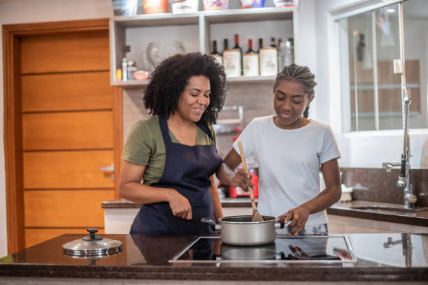 istock Mother and daughter cooking at home 1436280254