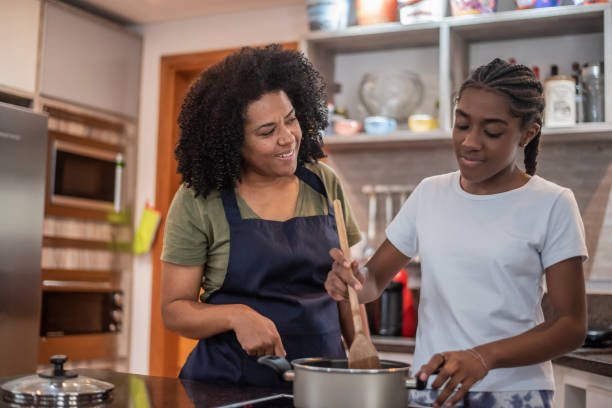 istock Mother and daughter cooking at home 1436280417