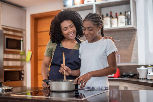 istock Mother and daughter cooking at home 1436280426