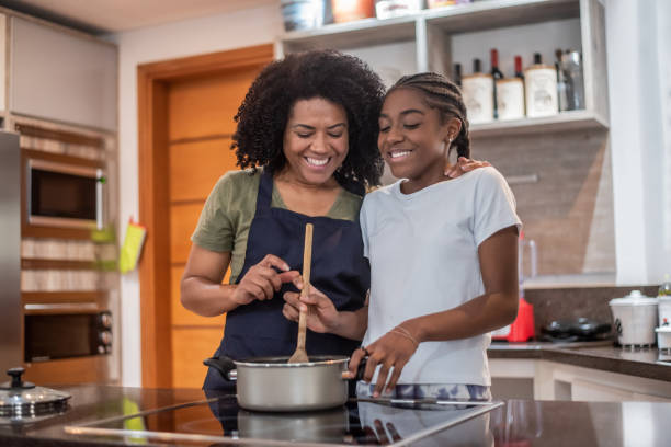 istock Mother and daughter cooking at home 1436280948