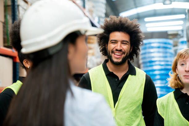 istock Meeting of diverse workers with female supervisor at a distribution warehouse all looking very cheerful 1436282809