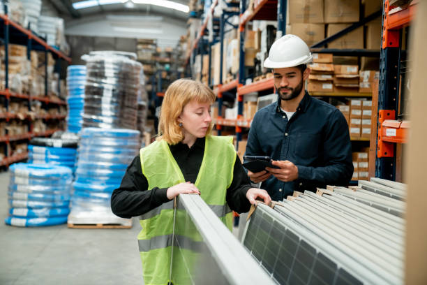 istock Male supervisor checking an order on tablet while female employee counts the solar panels at a distribution warehouse 1436282831
