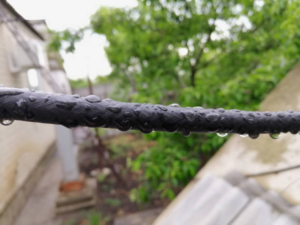 Wet cable hanging in the street after rain (in cloudy weather)