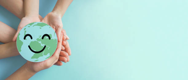 istock Hands holding earth with smile face, save planet, earth day, environment day, happy world, csr social responsibility, sustainable living  concept 1436283896