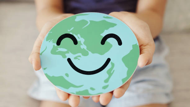 istock Hands holding earth with smile face, save planet, earth day, environment day, happy world, csr social responsibility, sustainable living  concept 1436286971