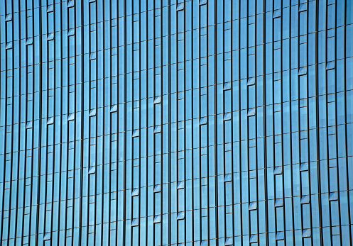 Blue sky reflected in a modern building glass facade