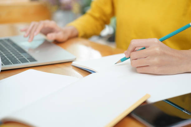 istock Close up of woman studying online using laptop. 1436305510