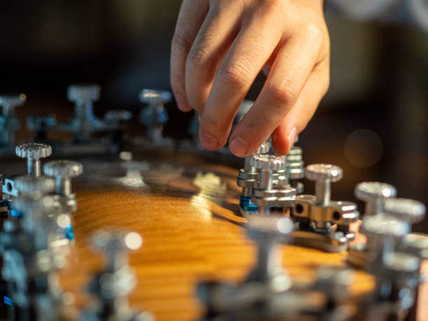 istock maker artisan clamping violin back to ribs using glue and locating pins 1436305903