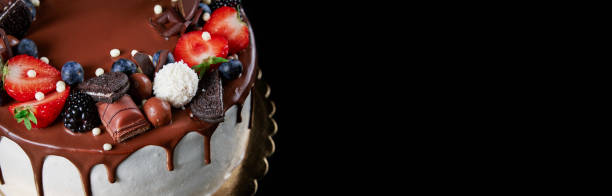Cake decorated with strawberry and chocolate on dark background