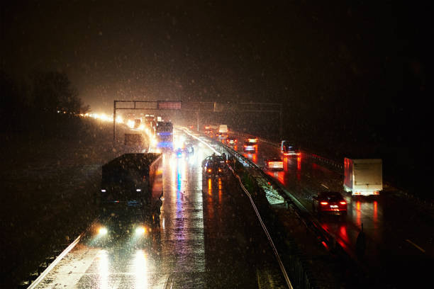 istock Car accident on slippery road at night during snowfall 1436308328