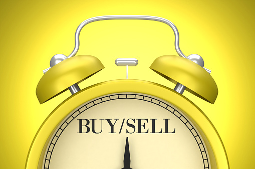 The yellow clock on the yellow background writes Buy And Sell. Planning concept.