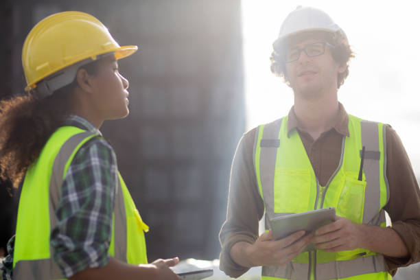 istock Young man and woman is architect planning and inspector project and looking digital tablet at construction site, engineer male and female working and examining for development real estate. 1436311257