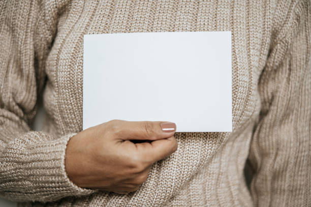 istock Hands holding opened card or letter. Blank cover Mock-up. 1436314753