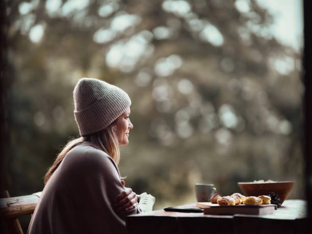 istock Smiling woman day dreaming on a patio. 1436317065