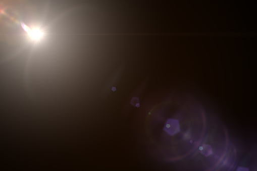 Lens Flare ,Sun Flare on black background. Lens flare glow light effect on black background for add overlay or screen filter over photos.