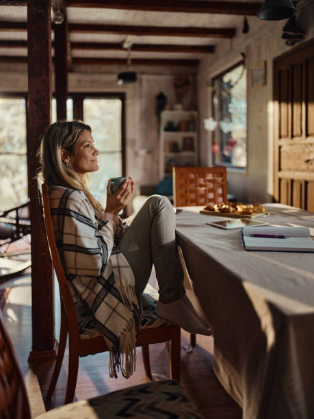 istock Relaxed woman day dreaming during coffee time at home. 1436317235
