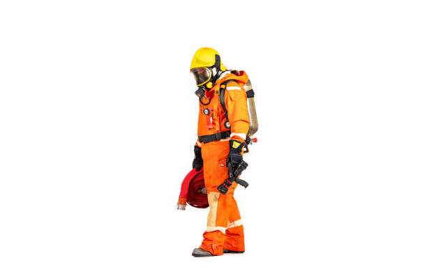 istock Firefighter man wearing protective fire suite and helmet with equipment and accessories is fire safety accident protection with white background. 1436317420