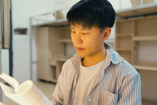 istock A college student in a college dormitory studies hard 1436317934