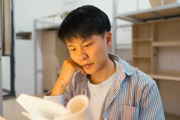 istock A college student in a college dormitory studies hard 1436317957