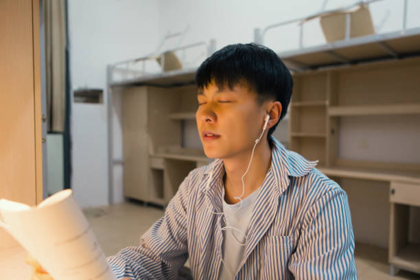 istock A college student in a college dormitory studies hard 1436319091