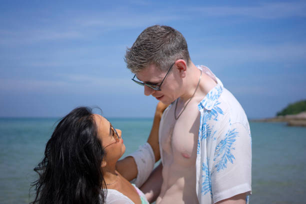 istock Young couple are walking on the beach. 1436320089