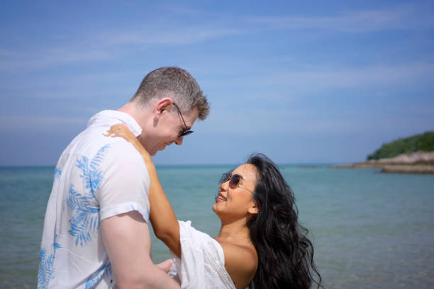 istock Young couple are walking on the beach. 1436320114