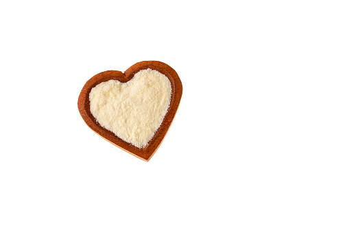 Powdered or dehydrated milk in the heart-shaped bowl
