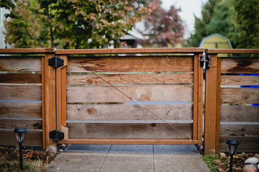 Wooden Gate of a fence in the front yard of a home.