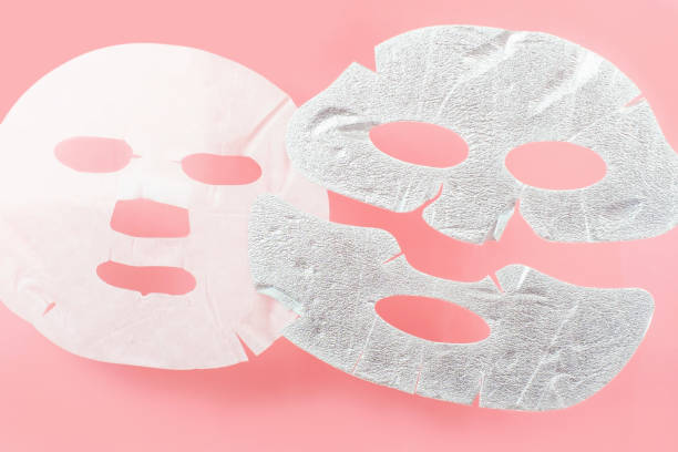 istock White and silver moisturizing sheet masks on a pink background close-up. 1436325480