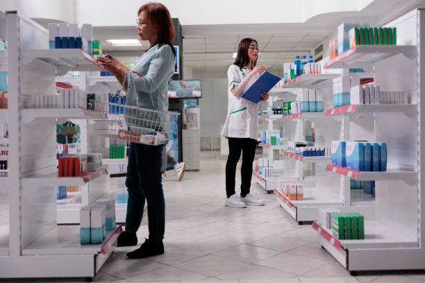 istock Pharmacy worker examining medical products 1436325600