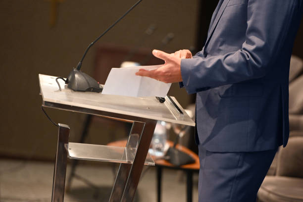 istock Businessman reading a speech at a conference 1436327105