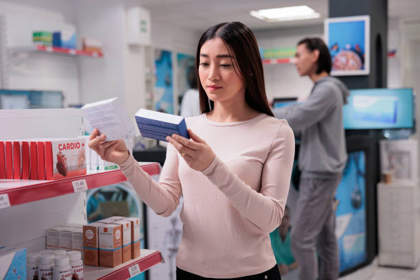 istock Asian woman analyzing packages of pills 1436331140